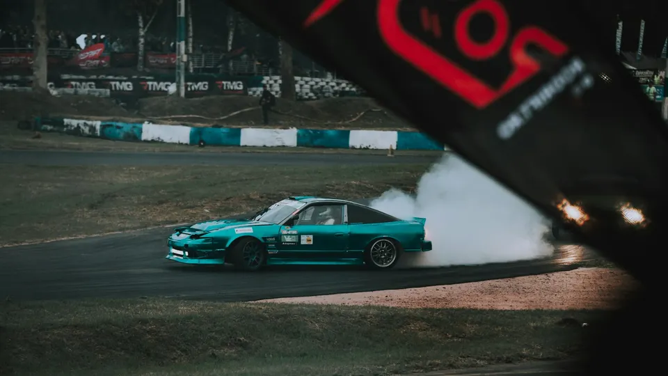 A drift car moving through tyre smoke — illustrative photograph