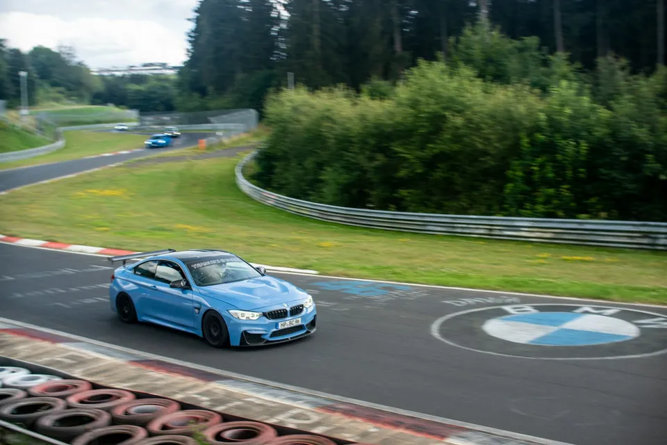 A blue performance coupe on a circuit — illustrative photograph